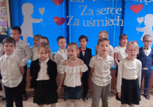 Dzieci śpiewają piosenkę podczas uroczystości z okazji Dnia Nauczyciela.