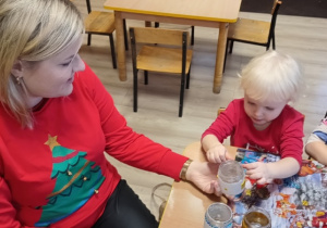 dziewczynka z mamą wykonuje ozdoby świąteczne