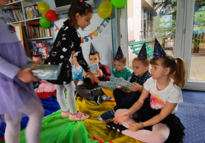 Dziewczynki wręczają prezenty jubilatom