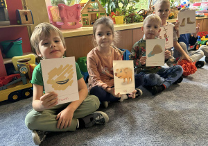 Dzieci pracują z kolorowymi obrazkami.