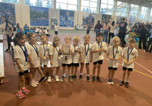 Dzieci prezentują medale i dyplom