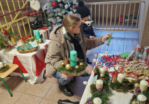 Dzieci z rodzicami kupują świąteczne ozdoby.