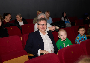 Burmistrz wraz z dziećmi oglądają przedstawienie.