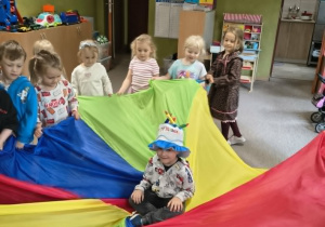 chłopiec siedzi na chuście animacyjnej