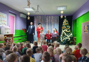 Dzieci wraz z artystami śpiewają kolędę.